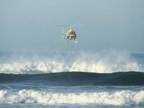 A helicopter being used to collect water samples from the surf-zone of the Sundays River beach.