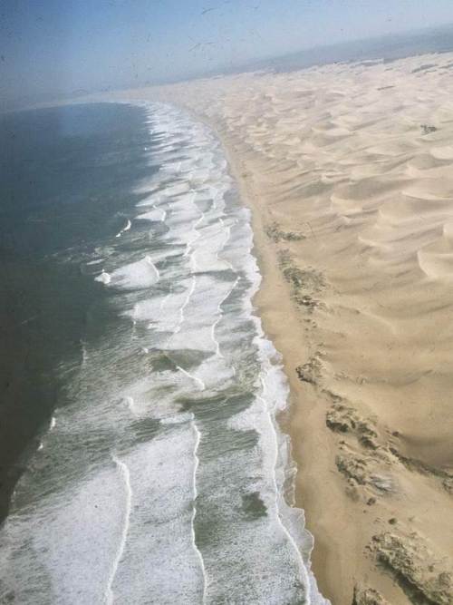 Aerial photograph of the Sundays River beach surf-zone. Brown discolouration of the surf foam is caused by the presence of billions of microscopic algae known as diatoms.